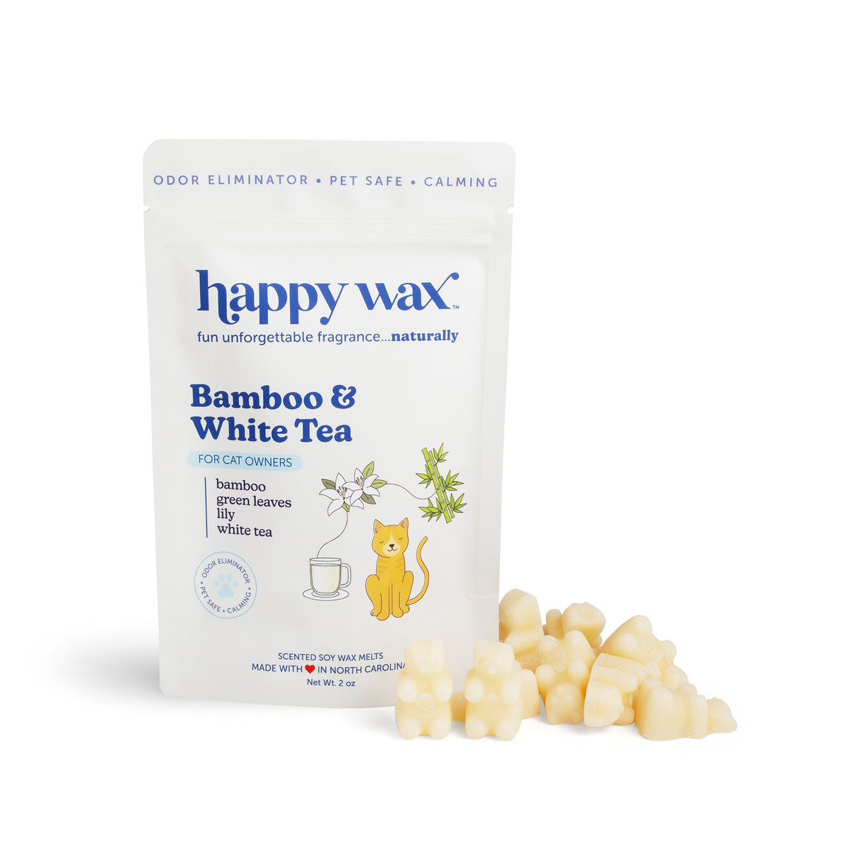 Cream-colored wax melts next to a white pouch labeled "Happy Wax Bamboo & White Tea" with cat and tea cup illustrations.