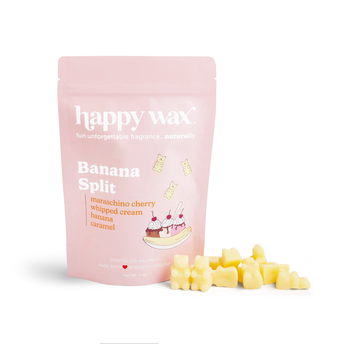 Pink pouch of Banana Split wax melts with yellow wax pieces scattered beside it.