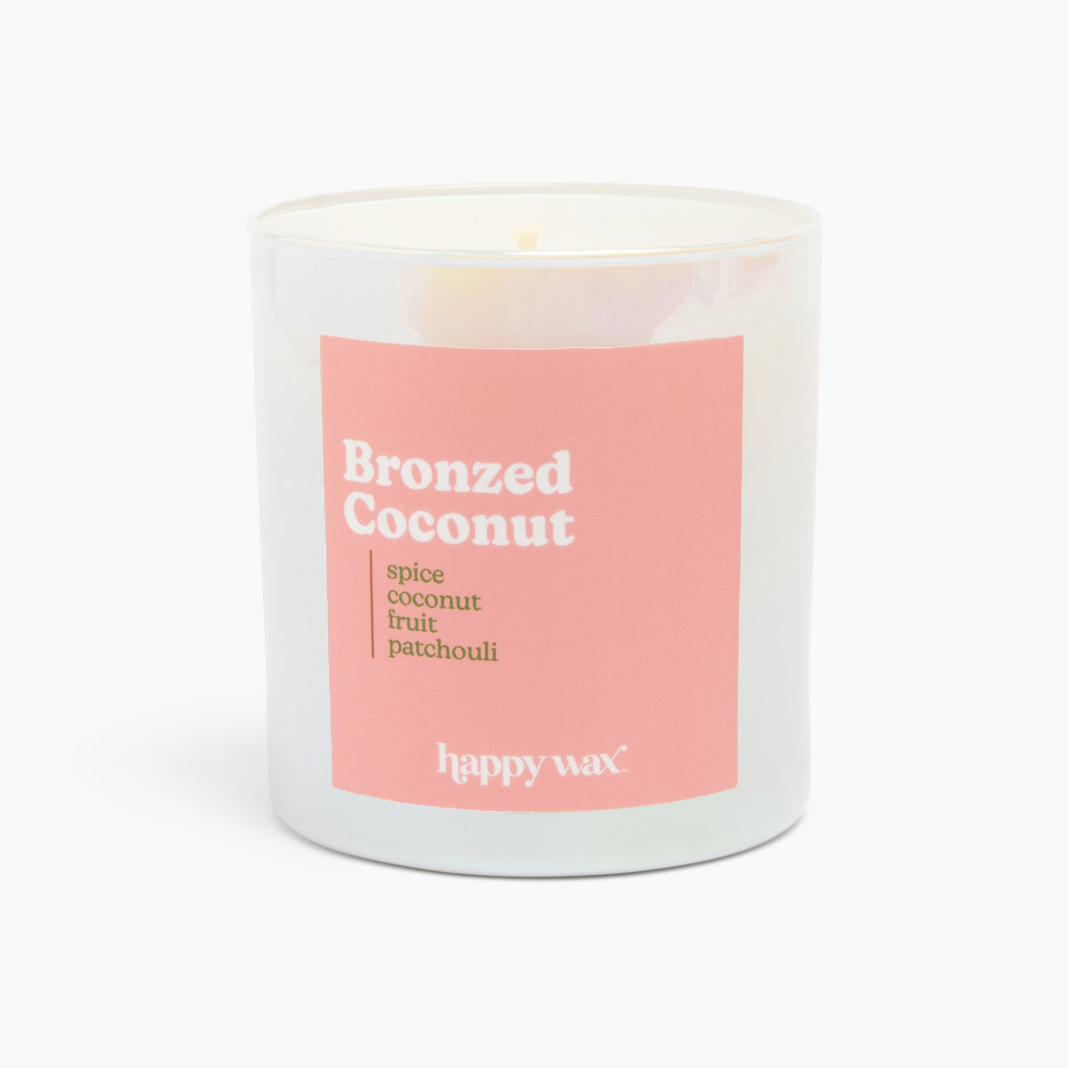 White cylindrical candle with pink label reading "Bronzed Coconut" and scent notes, single wick visible at top.