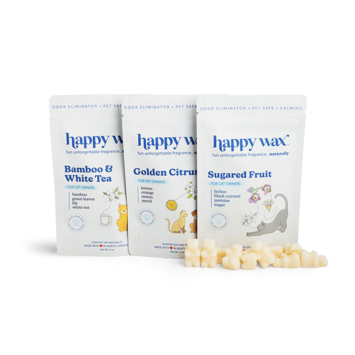 Three Happy Wax pouches labeled Bamboo & White Tea, Golden Citrus, and Sugared Fruit with wax melts displayed in front.
