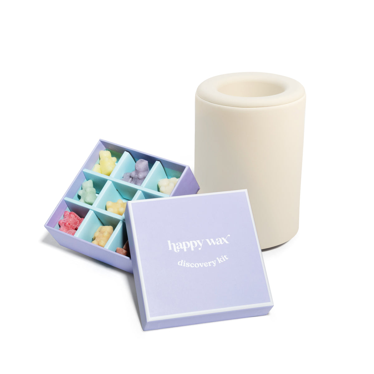 Purple box containing twelve assorted colored wax melts with cream ceramic warmer.