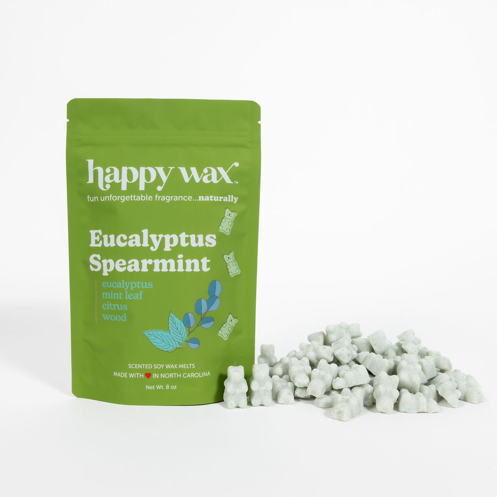 Green pouch of Happy Wax Eucalyptus Spearmint wax melts with white wax pieces displayed beside it.