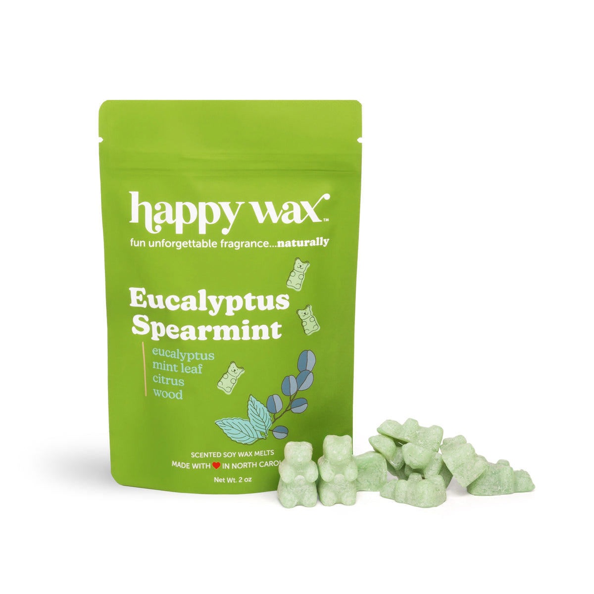 Green pouch of Happy Wax eucalyptus spearmint wax melts with loose pale green wax pieces scattered beside it.