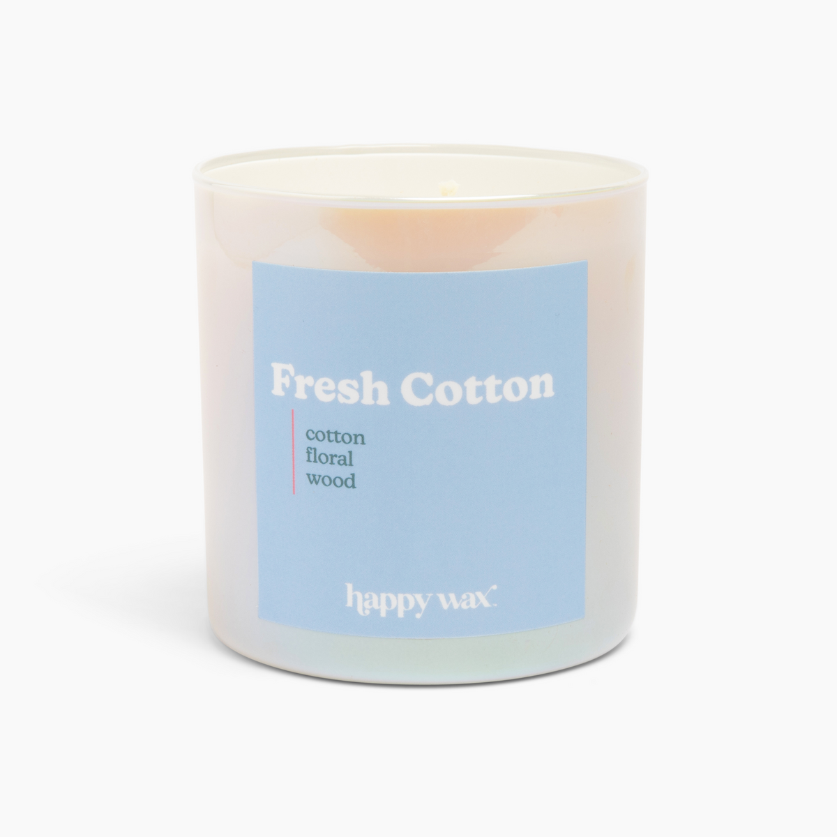 White cylindrical candle with blue label reading "Fresh Cotton" and scent notes, single wick visible at top.