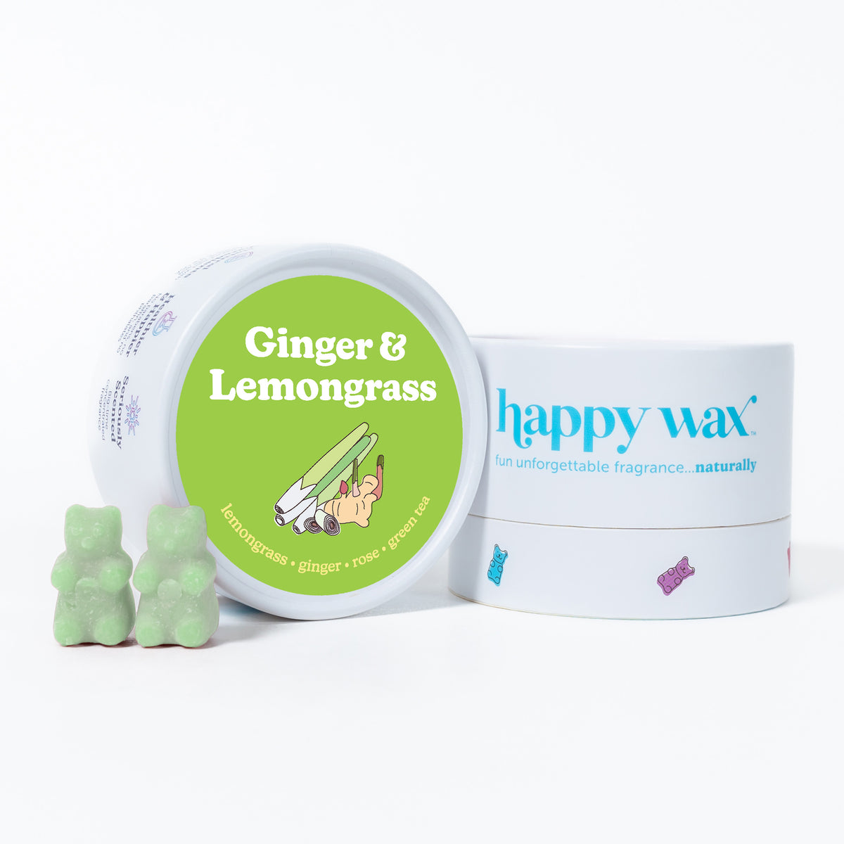 Green wax melts shaped like bears next to a white container labeled "Ginger & Lemongrass" by happy wax.