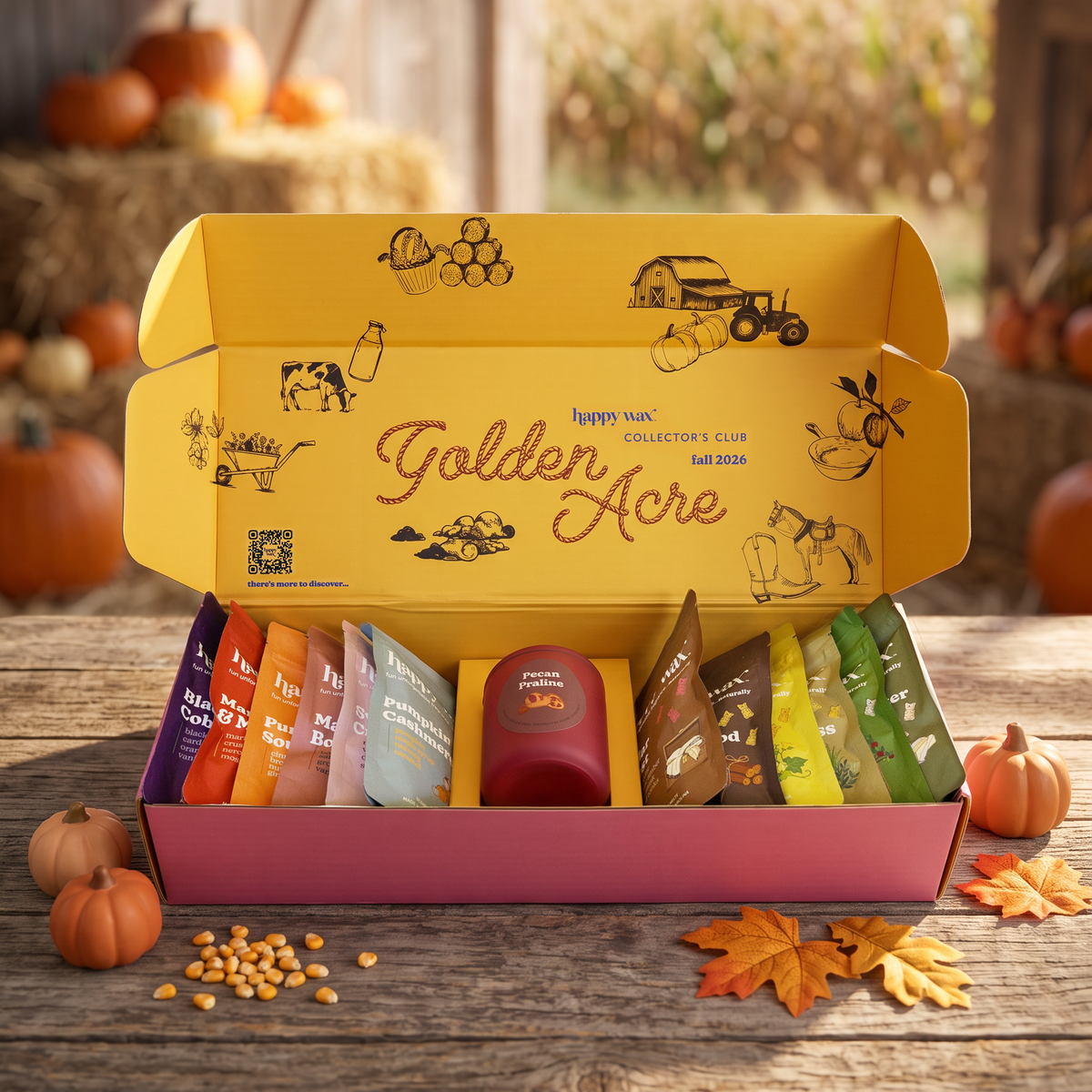 Happy Wax Golden Acre Collector's Club Fall seasonal box open displaying 13 scented wax melts on a wood table in a barn setting with pumpkins and hay.