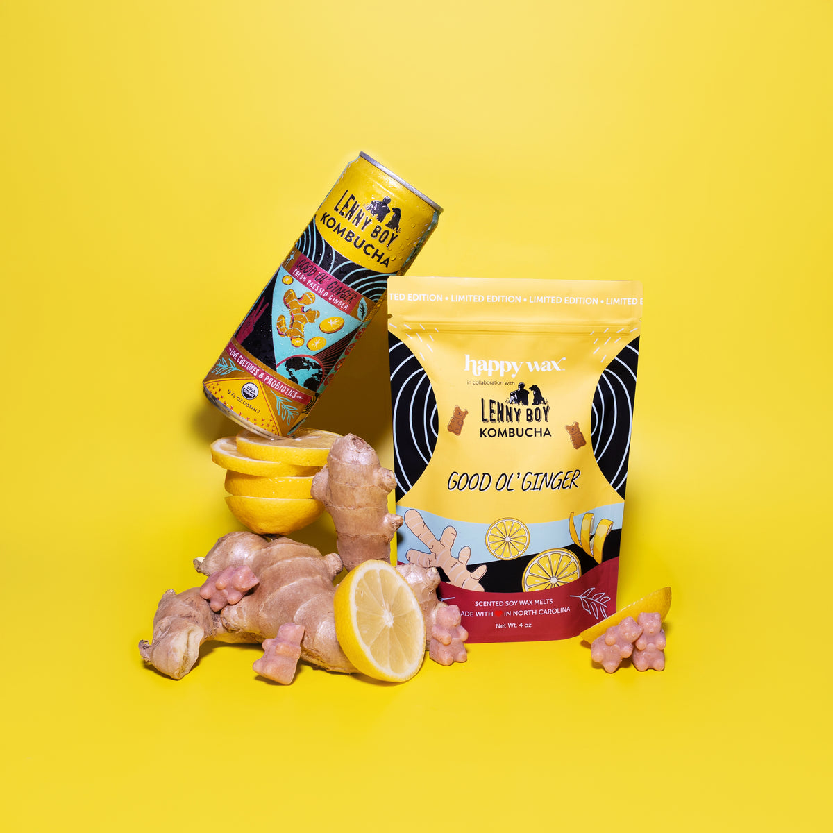 Good Ol' Ginger wax melts package with ginger root, lemon slices, and a kombucha bottle on yellow background.