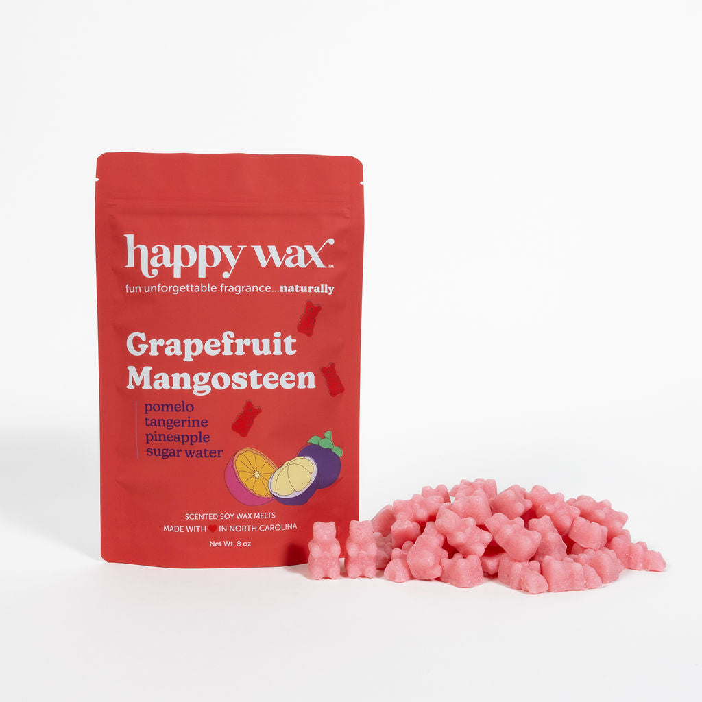 Red Happy Wax pouch of Grapefruit Mangosteen wax melts with pink wax chunks displayed beside it.
