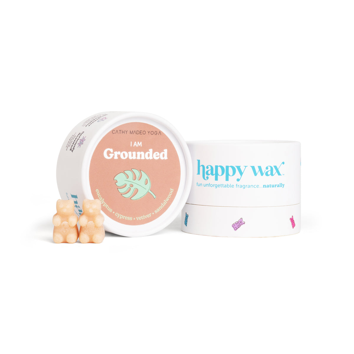 White container with peach-colored "I am Grounded" label, happy wax branding, and two cream-colored wax melts displayed in fr