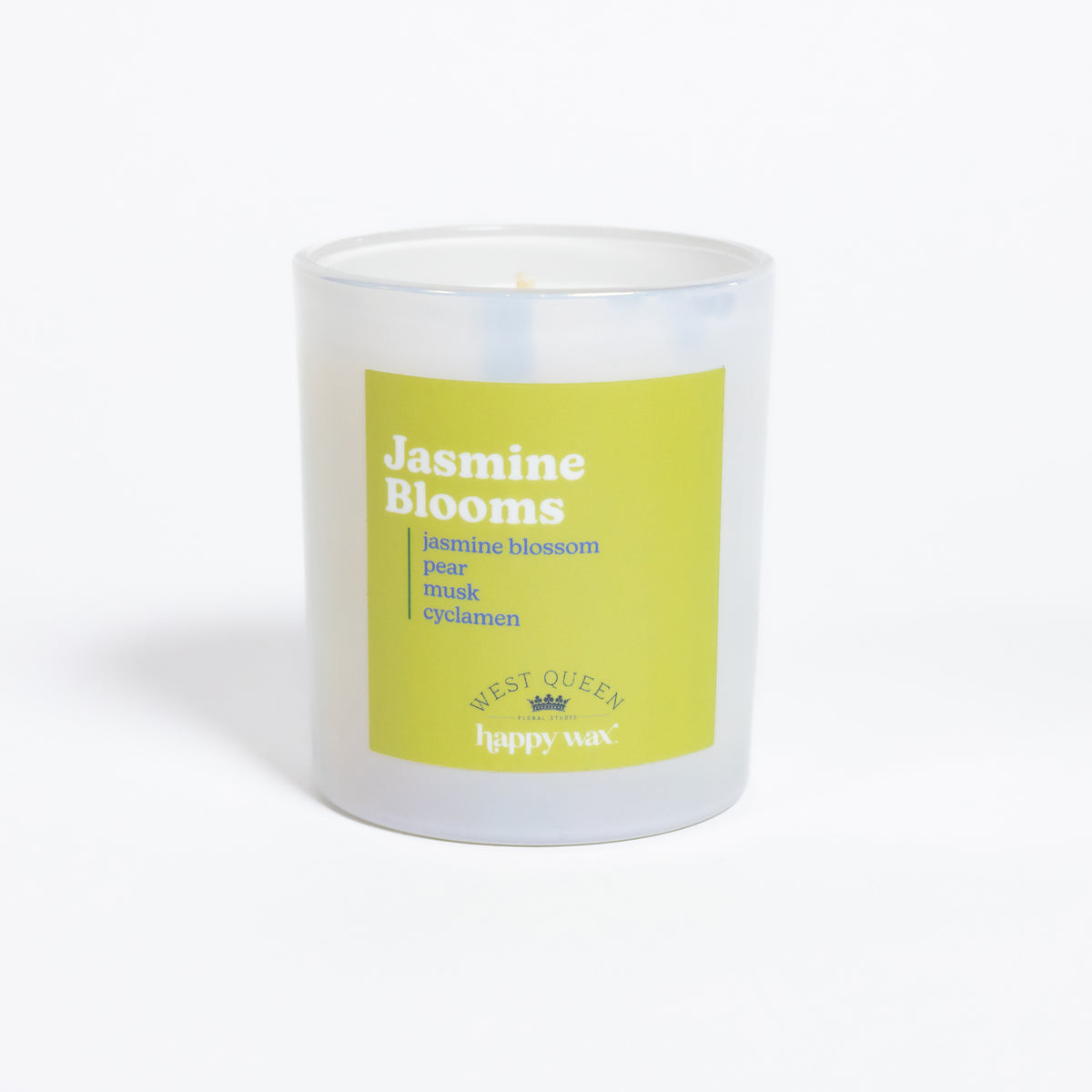 White glass candle with yellow label reading "Jasmine Blooms" and ingredient notes, single visible wick.