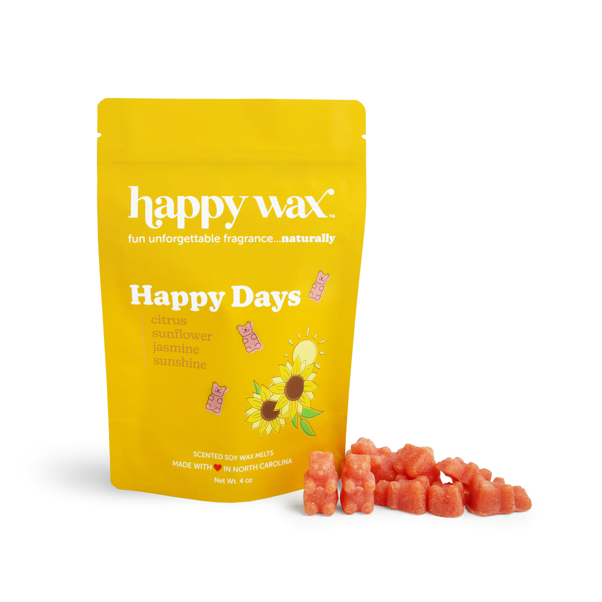 Yellow pouch of Happy Days soy wax melts with sunflower design, displayed with coral-colored wax melts scattered in front.