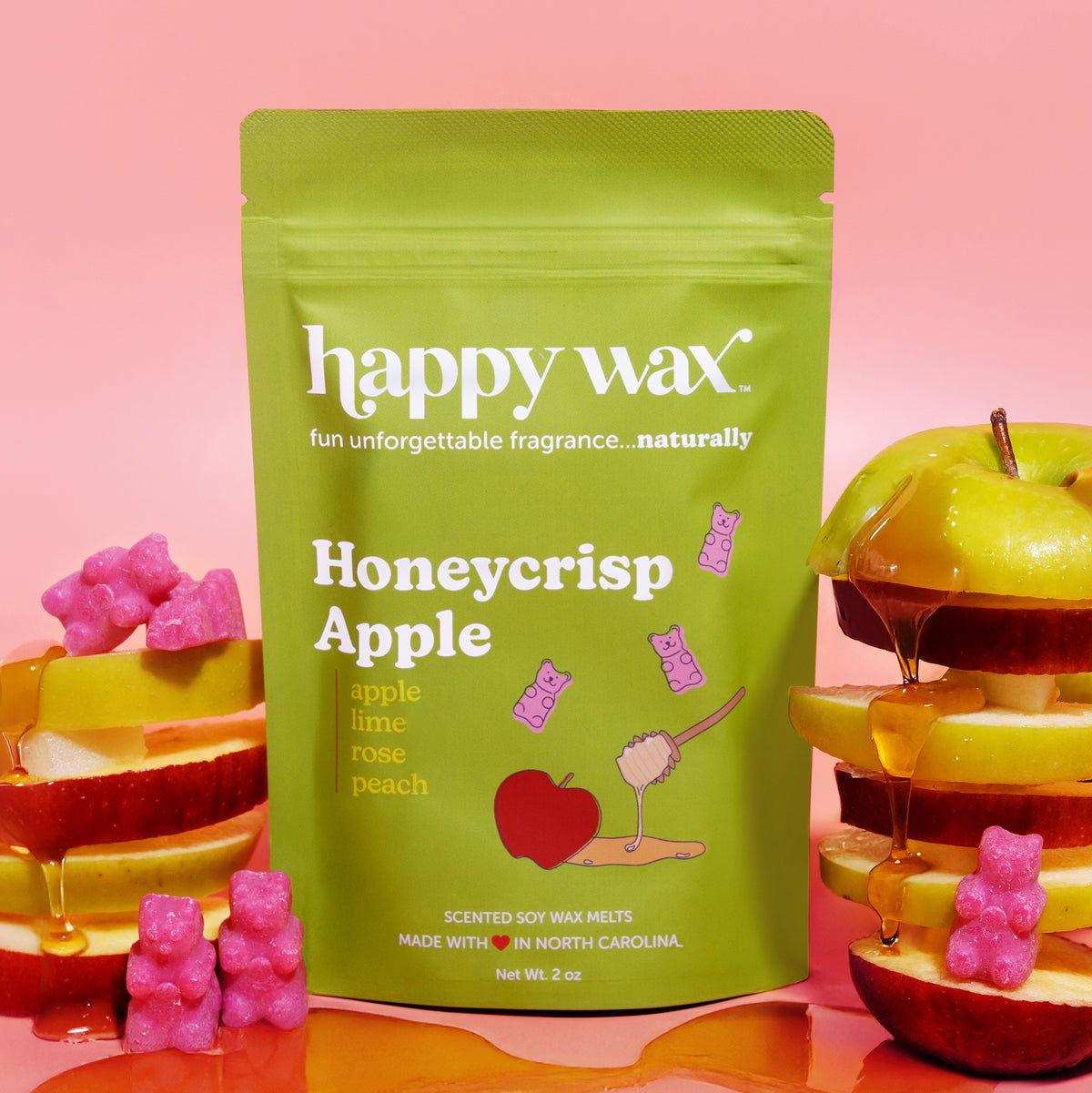 Happy Wax Honeycrisp Apple Pouch with apples and honey on pink background
