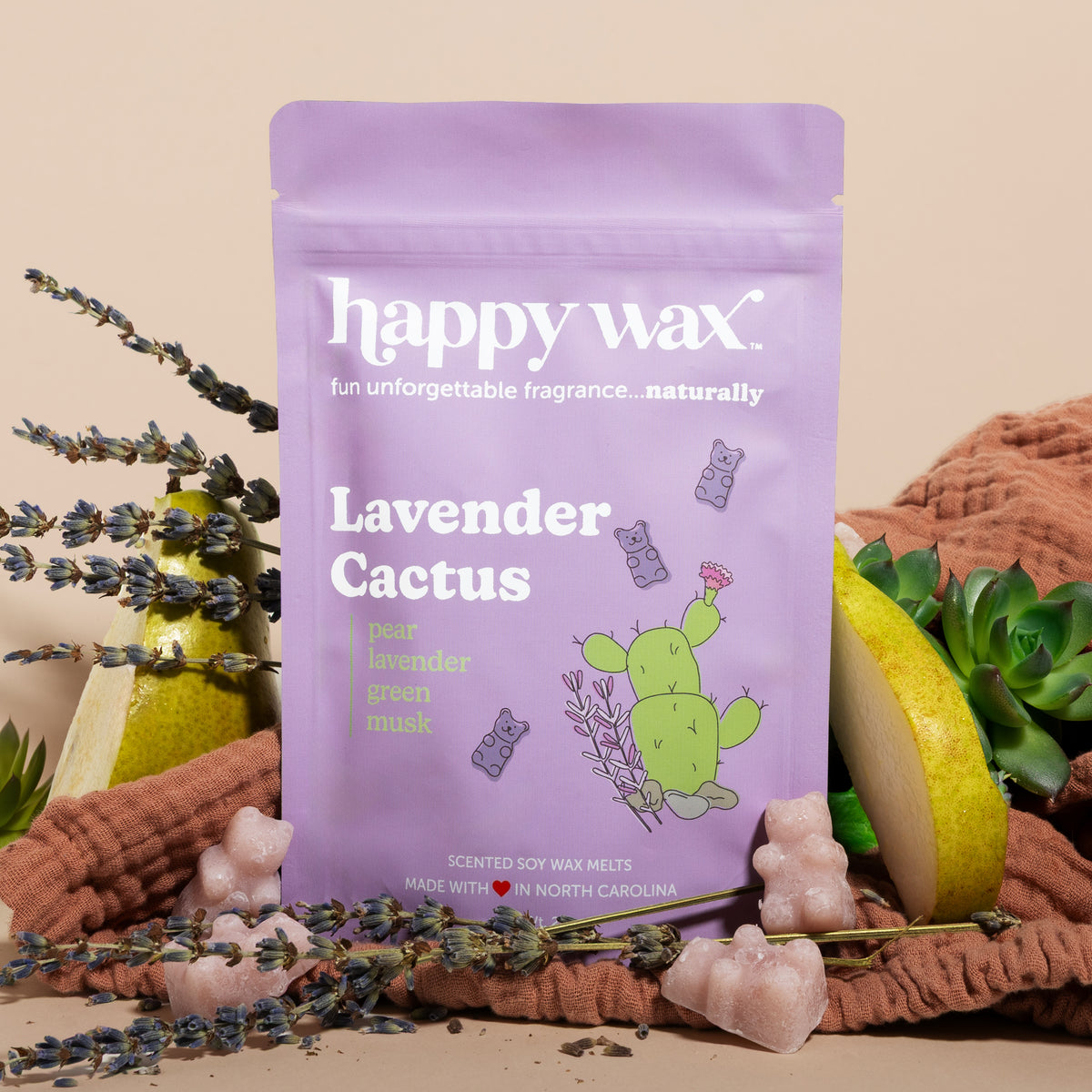 Happy Wax Lavender Cactus pouch with lavender, pears, succulents and rust colored linens on sand colored background