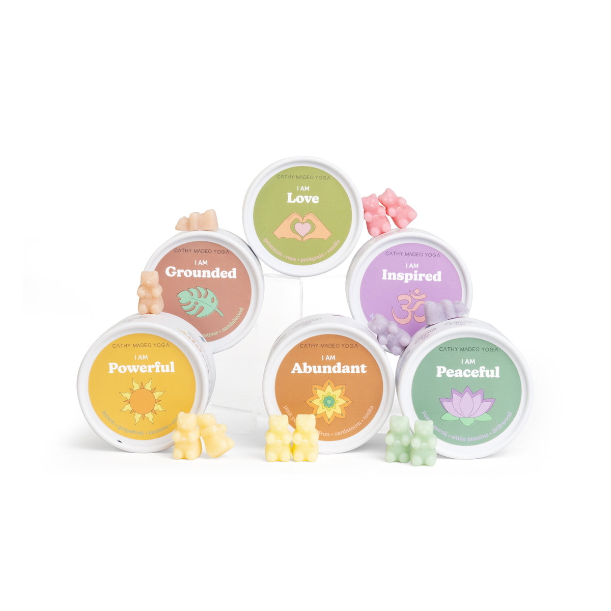 Six round wax melts in assorted colors labeled Love, Grounded, Inspired, Powerful, Abundant, and Peaceful, each with matching