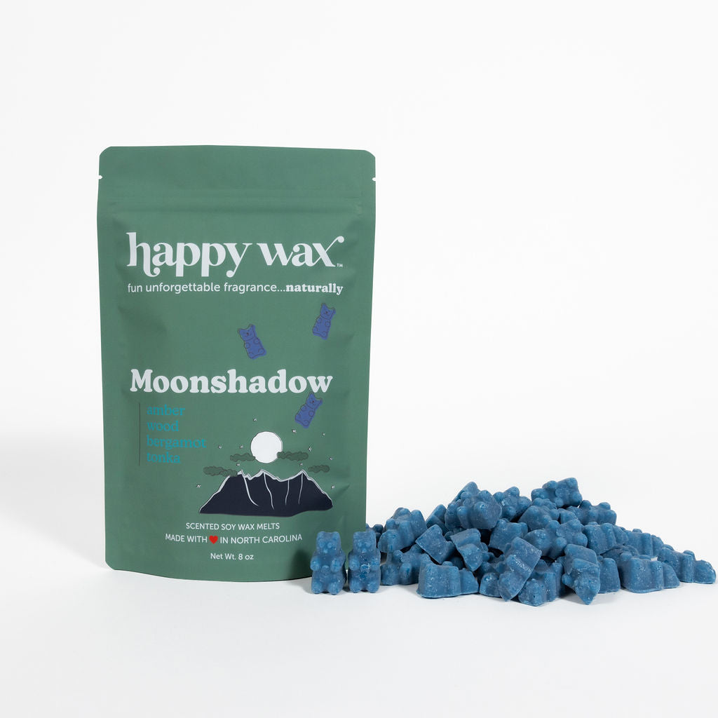 Green Happy Wax pouch labeled Moonshadow next to blue wax melt cubes.