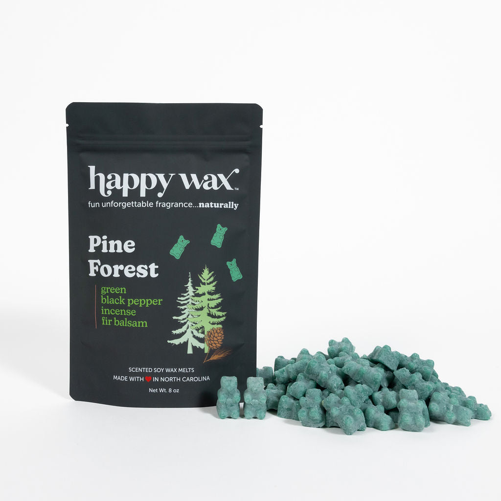 Black pouch of Happy Wax Pine Forest scented wax melts with green wax pieces displayed beside it.