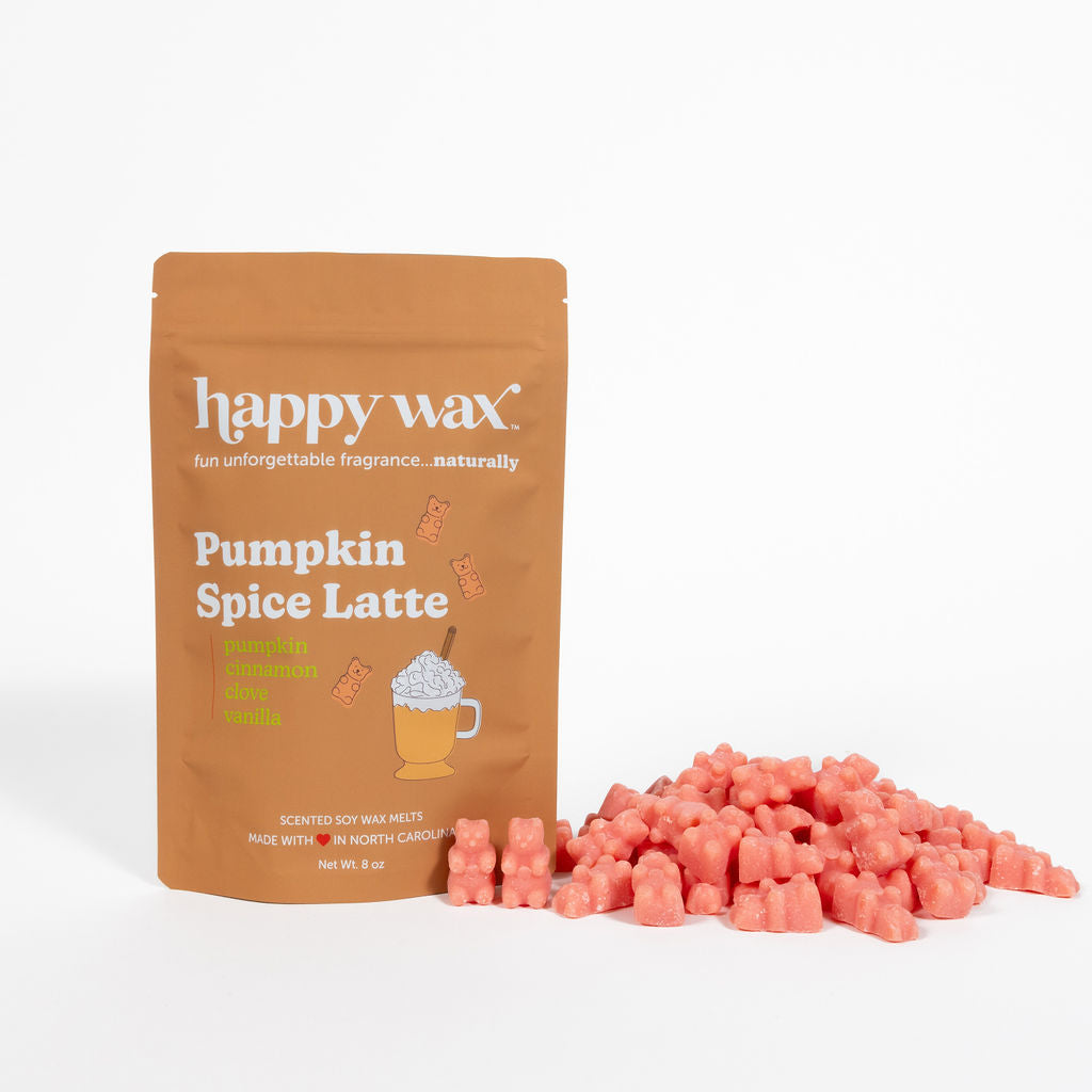 Tan pouch of Happy Wax Pumpkin Spice Latte scented soy wax melts with coral-colored wax cubes displayed beside it.