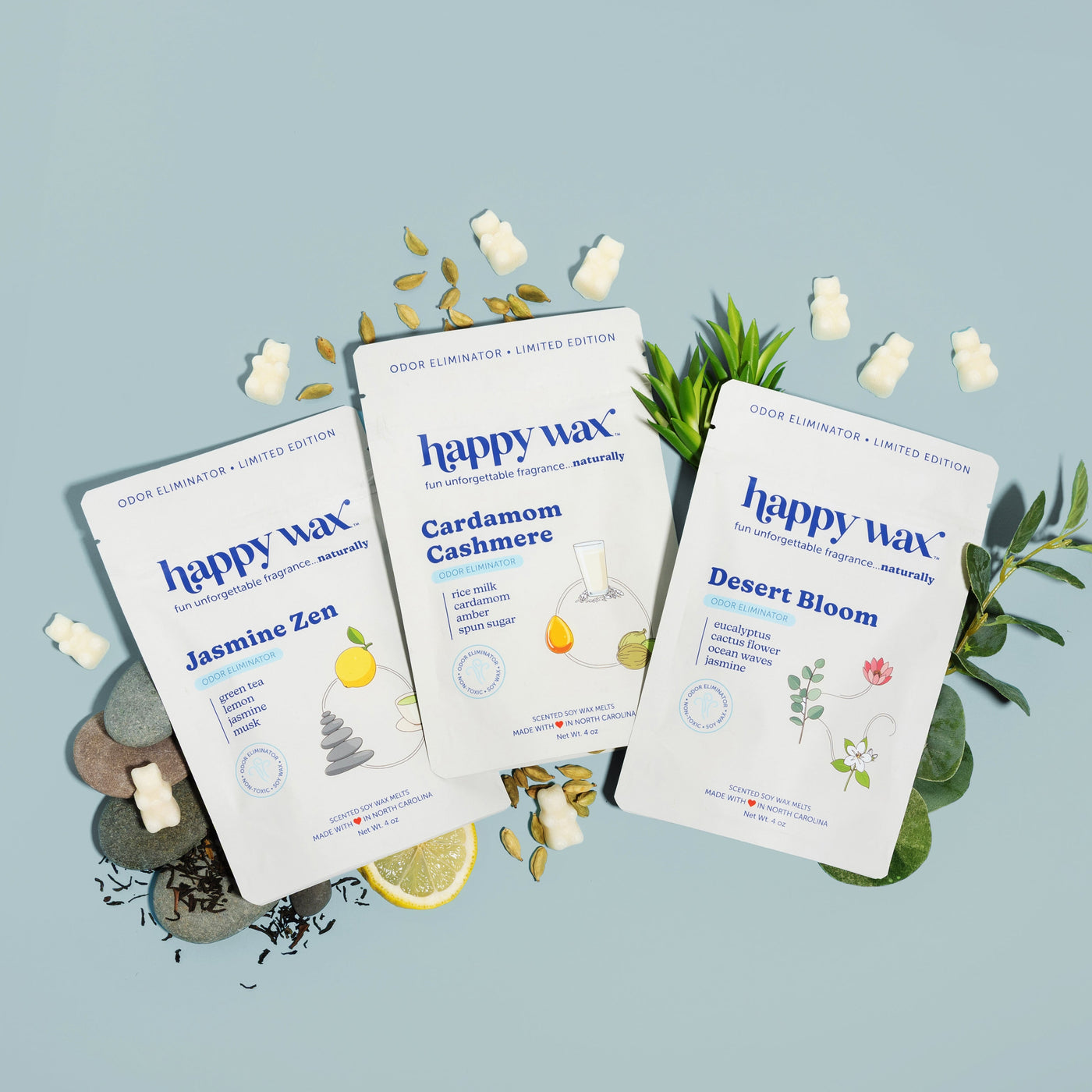 Happy Wax Pure Peace 3 pack with cardamom, rice milk, smooth rocks, lemon, eucalyptus, succulent and wax bears on grey blue background