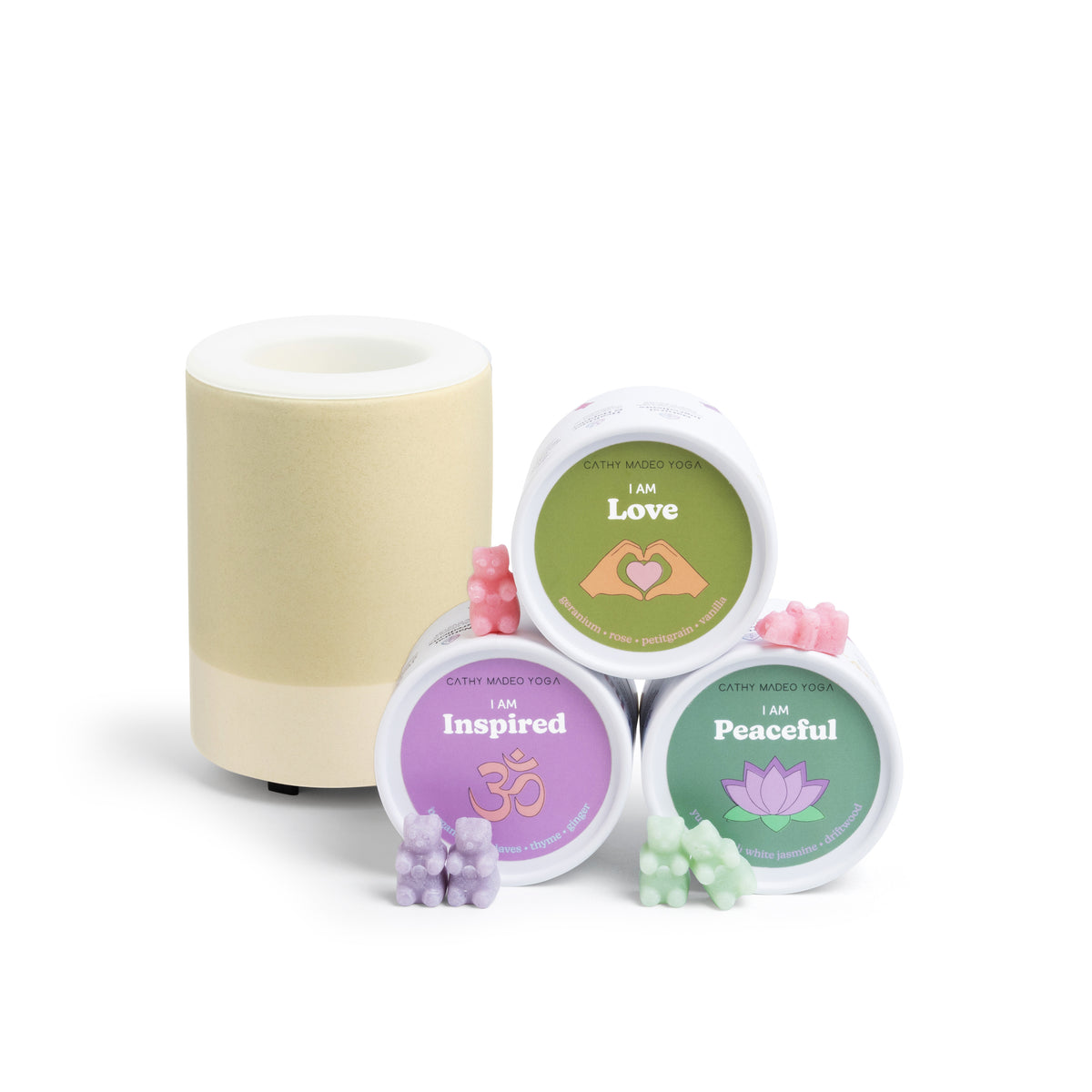 Cream-colored cylindrical diffuser with three labeled wax melts in green, purple, and pink containers alongside colored wax m