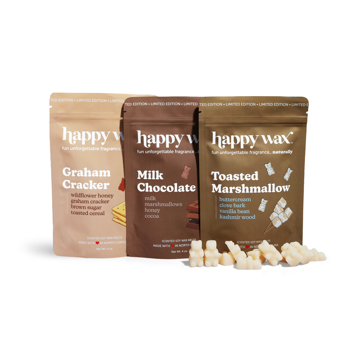 Three Happy Wax soy wax melts in Graham Cracker, Milk Chocolate, and Toasted Marshmallow scents with scattered wax pieces.