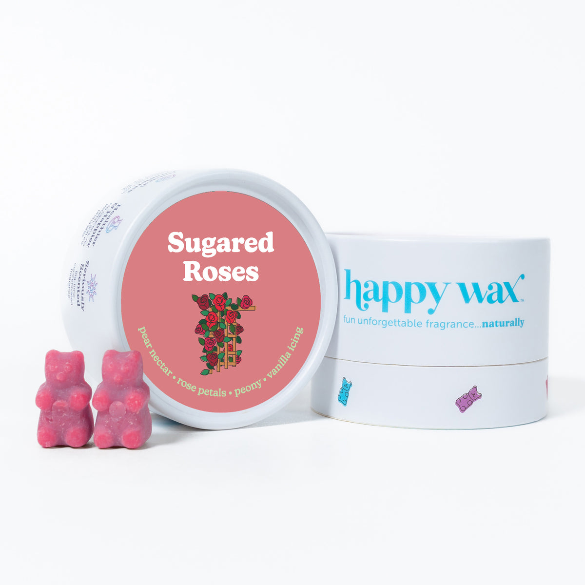 Pink wax melts shaped like bears next to a round container labeled Sugared Roses and happy wax branded packaging.