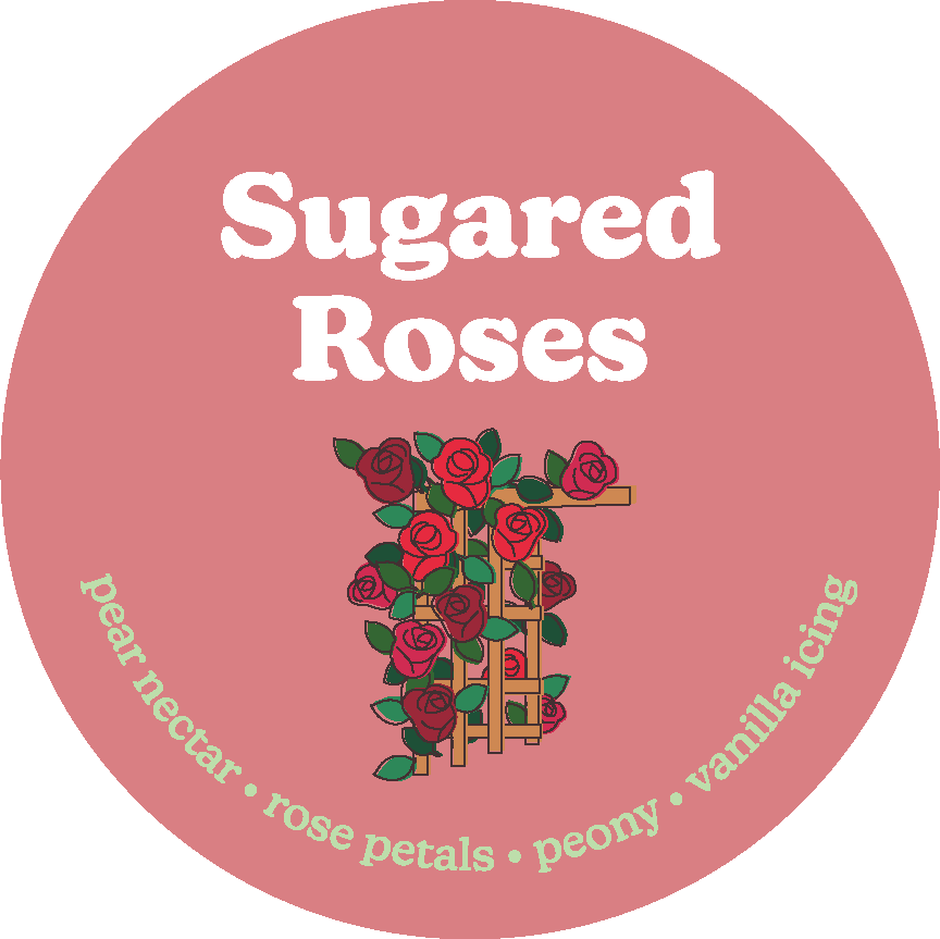 Round dusty rose label with white "Sugared Roses" text and illustrated red roses on wooden trellis with green leaves.