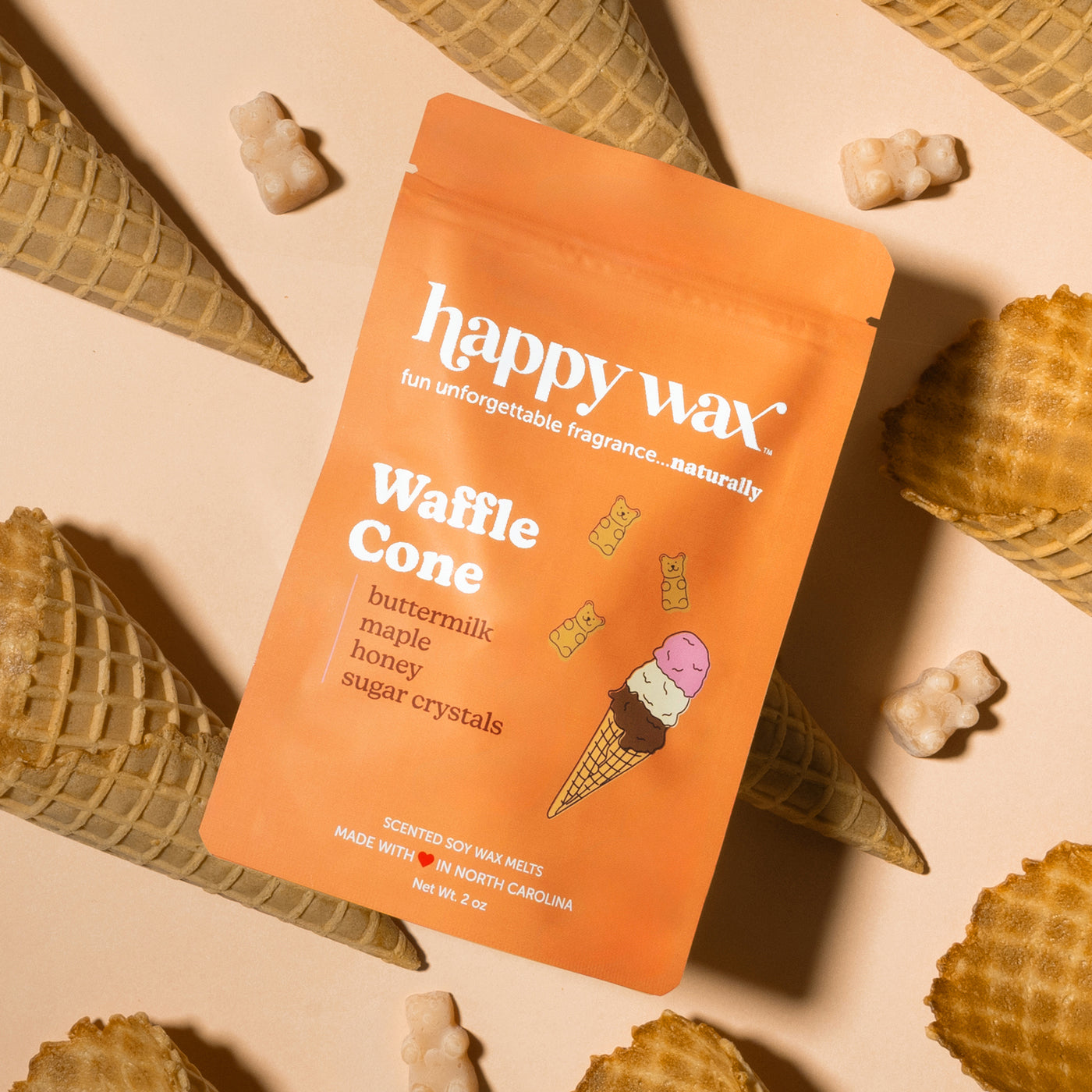 Orange Happy Wax pouch of Waffle Cone scented soy wax melts surrounded by waffle cones and wax pieces.