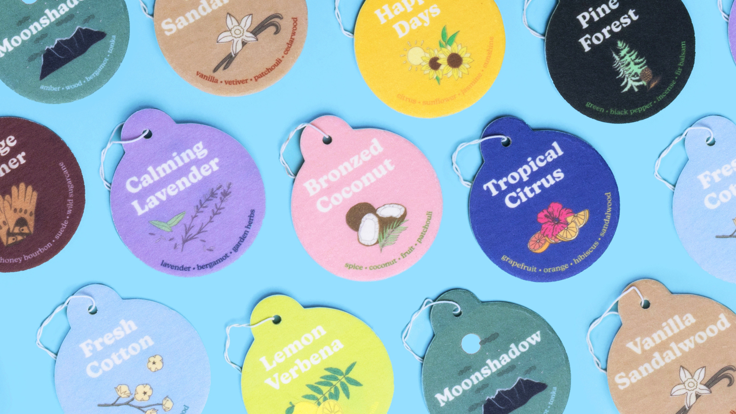 Happy Wax scented Car charms - Tropical Citrus, Bronzed Coconut, Calming Lavender, Happy Days, Pine Forest, Lemon Verbena, Moonshadow, Vanilla Sandalwood, Fresh Cotton, Vintage Leather - on blue background