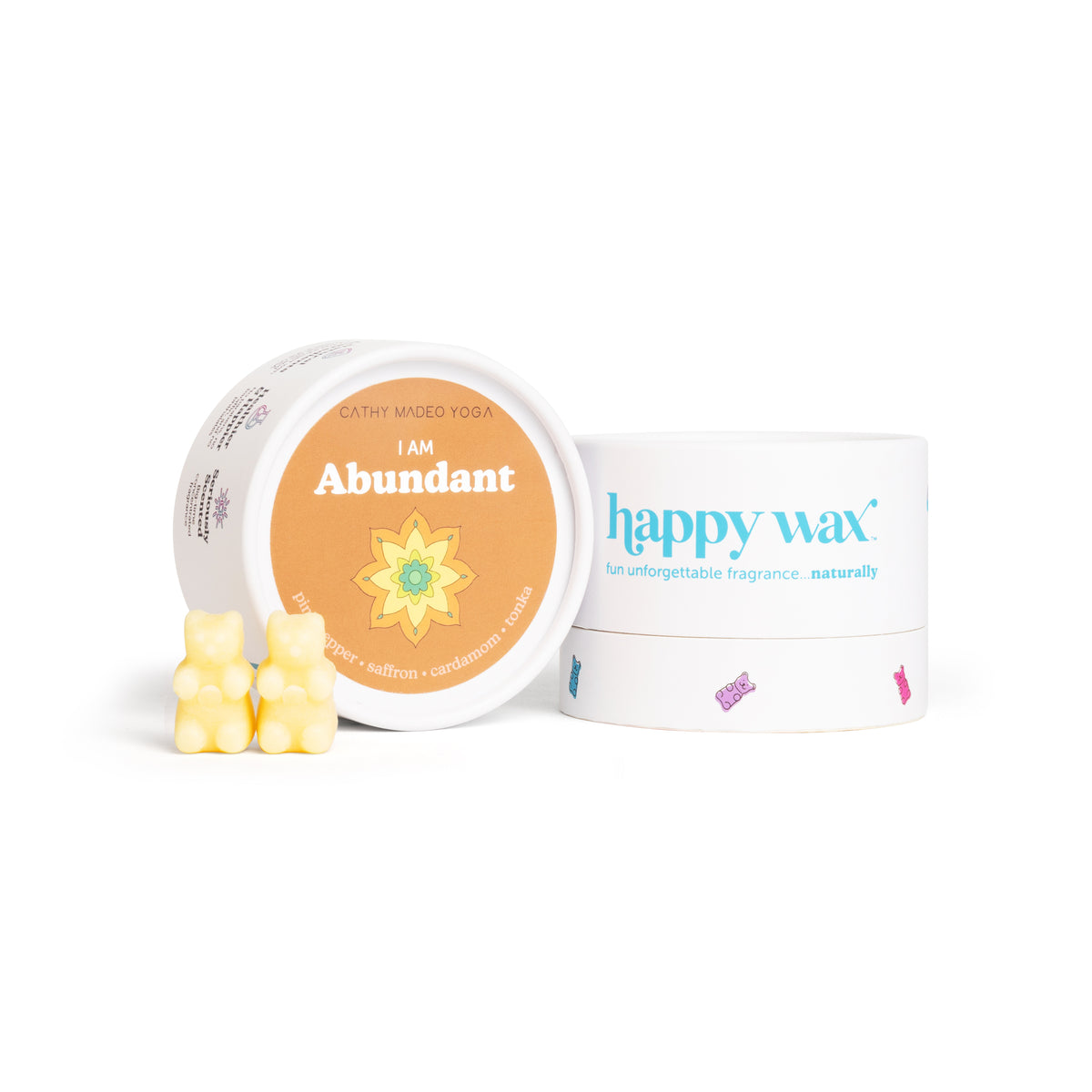 Yellow wax melts in front of an orange "I am Abundant" container and white "happy wax" branded box.