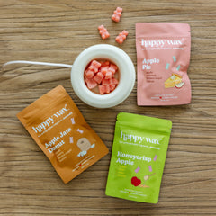 Happy Wax Apple Stand 3 pack packaging with mod warmer on wood surface