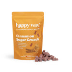 Gold pouch of Happy Wax cinnamon sugar crunch scented soy wax melts with brown wax pieces displayed beside it.
