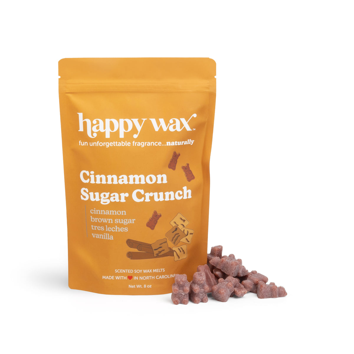 Gold pouch of Happy Wax cinnamon sugar crunch scented soy wax melts with brown wax pieces displayed beside it.