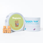 Two peach-colored bear-shaped wax melts displayed with a round green lidded container and white Happy Wax branded box.