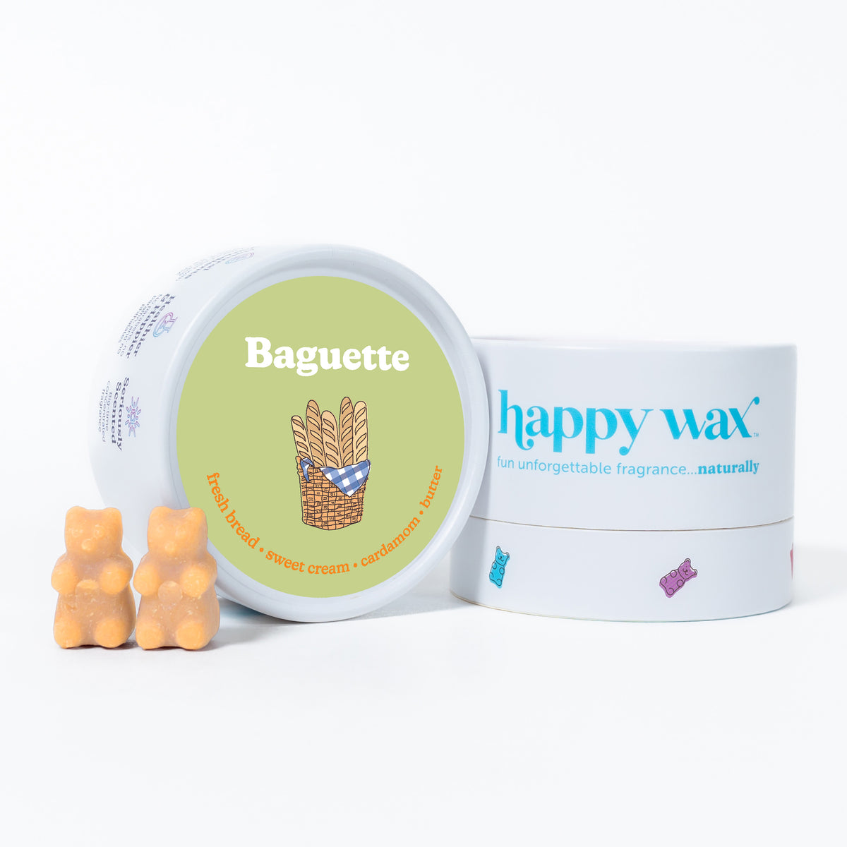 Two peach-colored bear-shaped wax melts displayed with a round green lidded container and white Happy Wax branded box.