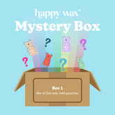 Cardboard box with colorful wax melts shaped like bears emerging above, with question marks indicating unknown contents.
