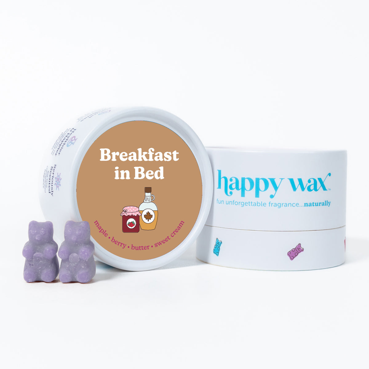 Purple bear-shaped wax melts next to white container labeled "Breakfast in Bed" with happy wax branding.