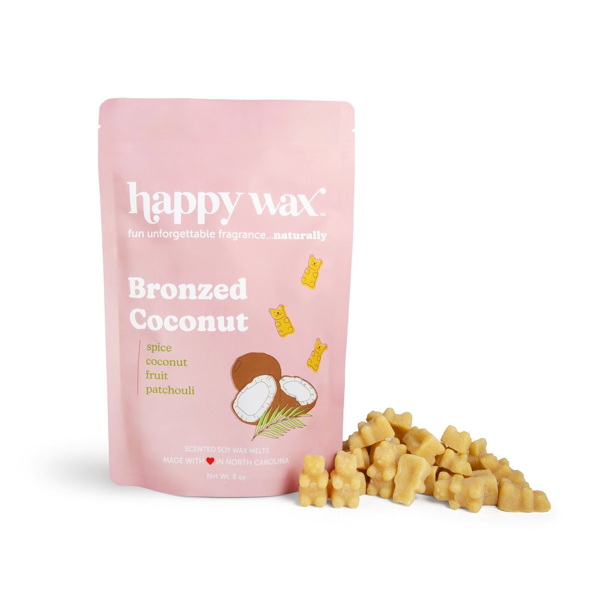 Pink pouch of Happy Wax Bronzed Coconut wax melts with yellow wax chunks displayed in front.