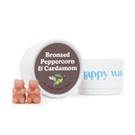 Peach-colored bear-shaped wax melts displayed with white container and branded packaging.