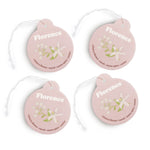 Four pink round car charms with "Florence" text, floral illustrations, and scent descriptions with attached string loops.