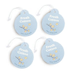 Four light blue circular car charms with white string attached, each featuring "Fresh Cotton" text and dried cotton flower il