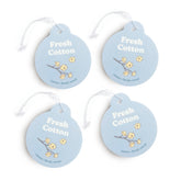 Four light blue circular car charms with white string attached, each featuring "Fresh Cotton" text and dried cotton flower il