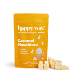 Gold pouch of Happy Wax caramel macchiato scented soy wax melts with cream-colored wax pieces displayed in front.