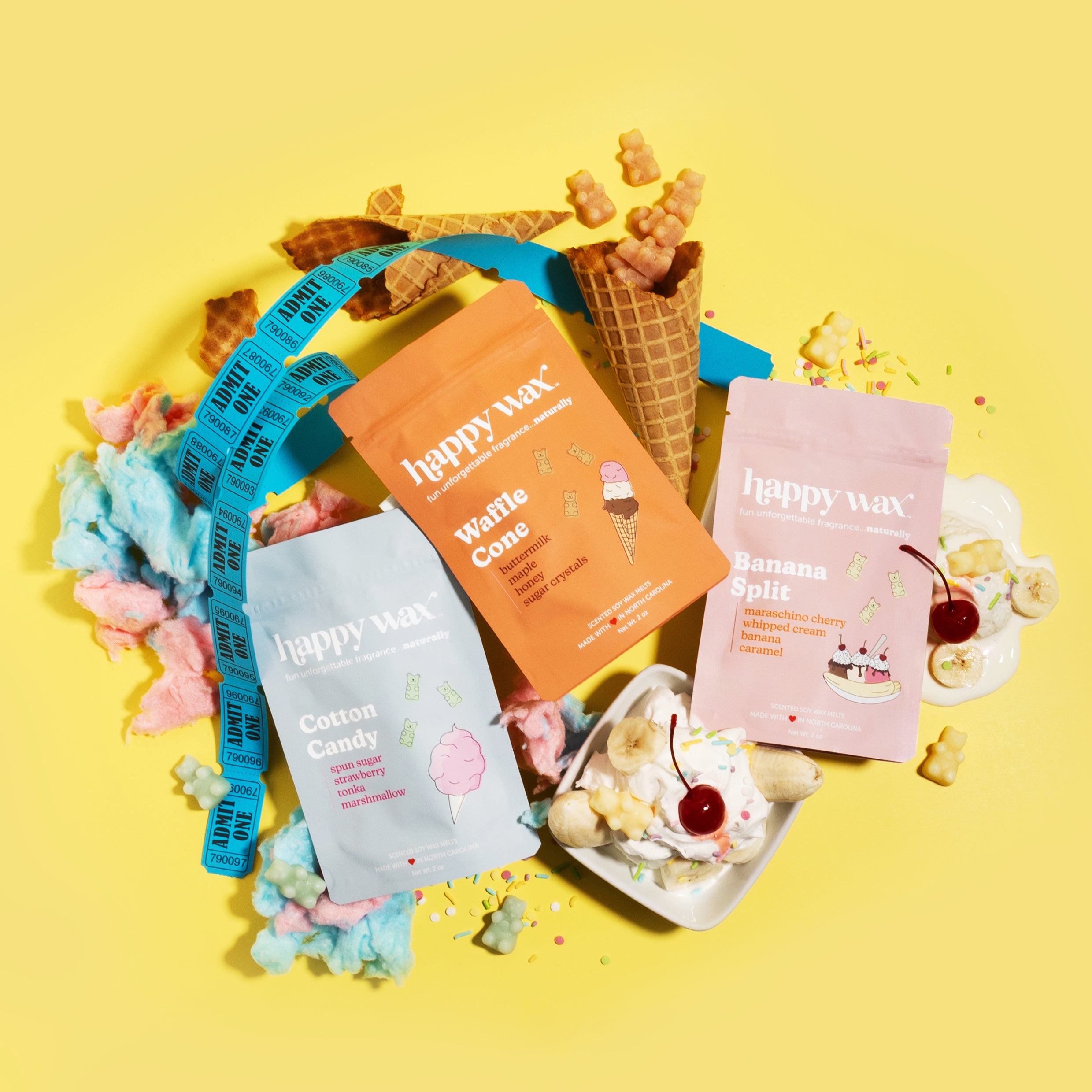Happy Wax Carnival Collection wax melts packaging with carnival designs, ice cream, cotton candy and sprinkles on a yellow background