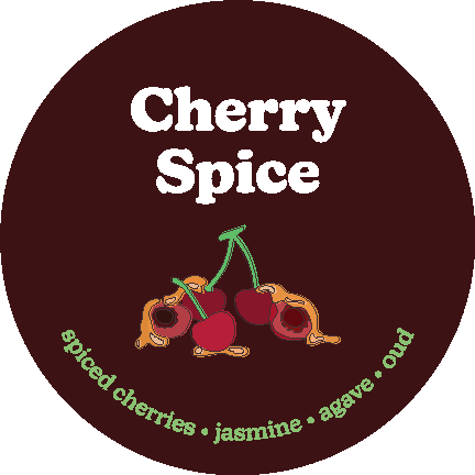 Dark burgundy circular label with "Cherry Spice" text, illustrated cherries, and green text listing scent notes.