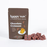 Brown pouch of Happy Wax chocolate croissant scented soy wax melts with illustrated croissant and individual wax pieces displ