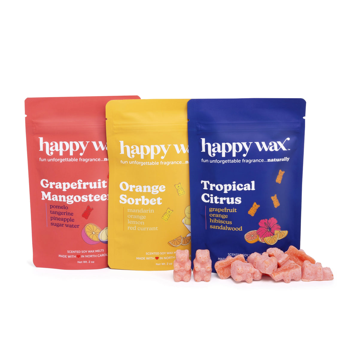 Three happy wax pouches in red, yellow, and blue with scattered pink wax melts in front.