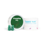 Green wax melts in a white container with green lid labeled "Creeping Ivy" next to Happy Wax packaging and four green bear-sh