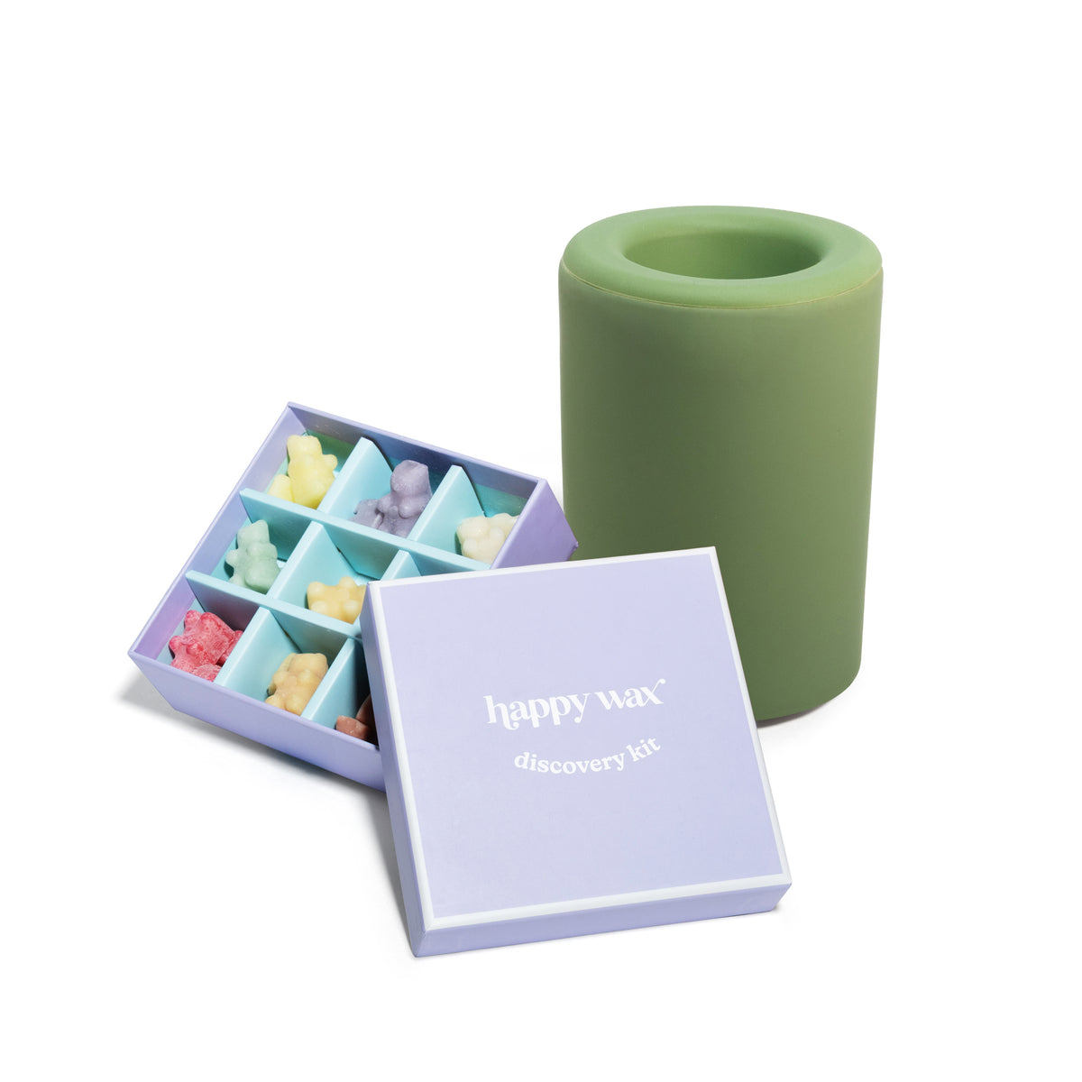 Purple box containing nine colored wax melts next to a green cylindrical warmer.