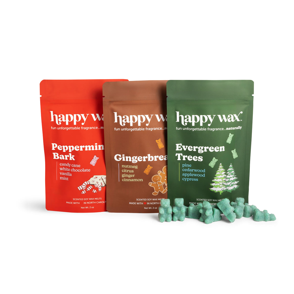 Three Happy Wax scented soy wax melt pouches in red, brown, and green with loose wax melts in front.