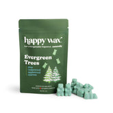 Green resealable pouch of happy wax Evergreen Trees soy wax melts with scattered light green wax pieces beside it.